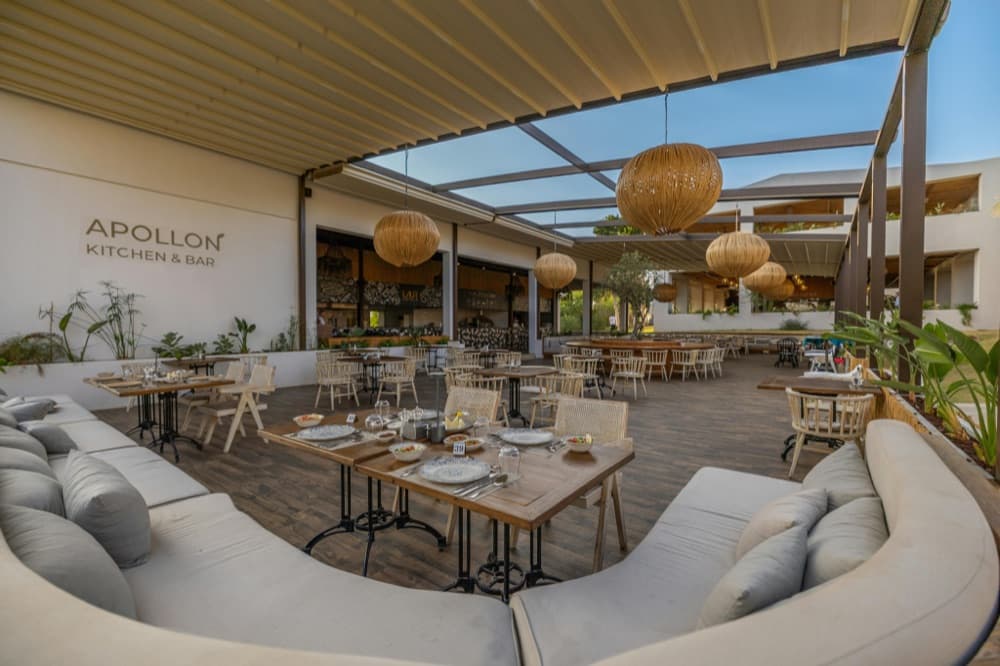 Restaurant dining room with open kitchen and pendant lighting