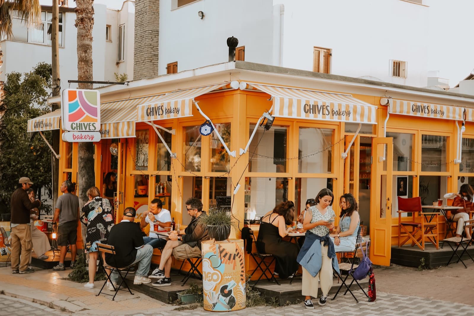 Busy café storefront with customers seated outside